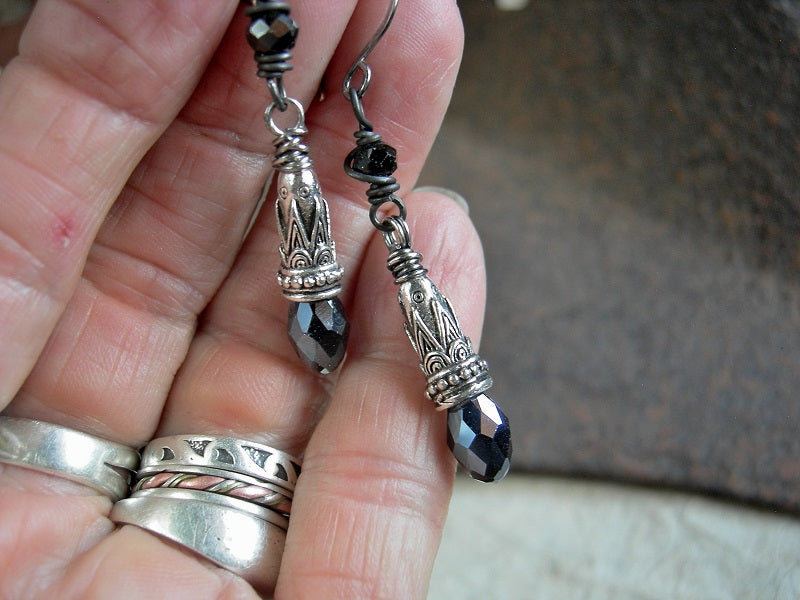 Elegant black & silver drop earrings with faceted tourmaline cubes, ornate silver cone caps & silvery black crystal teardrops. 