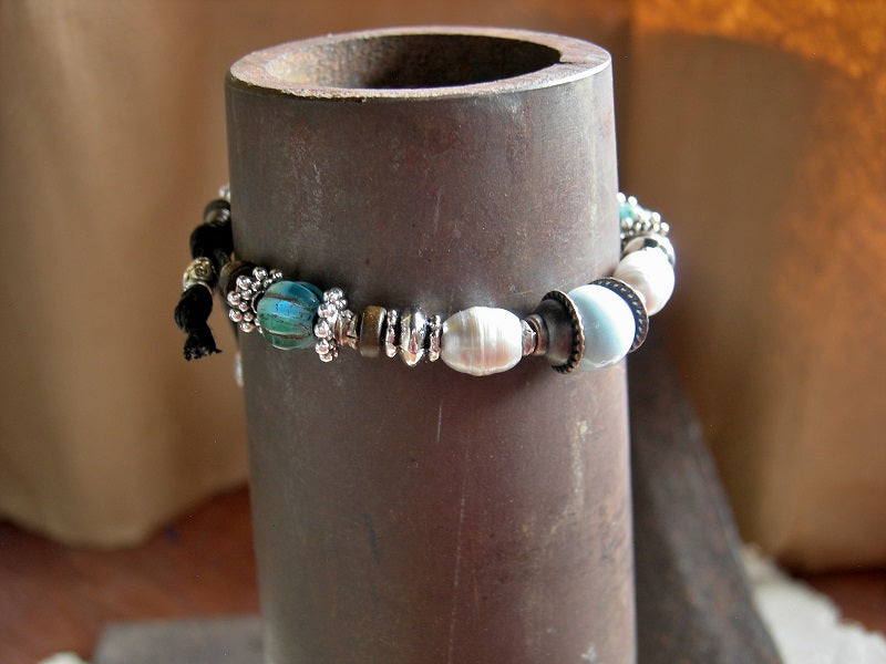 Adjustable boho slider bracelet with white freshwater pearls, pale blue ceramic beads & turquoise colored glass melon beads. Silver & copper mixed metal.