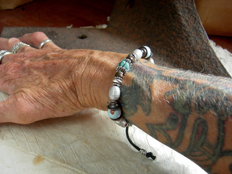 Elegant adjustable slider bracelet with white freshwater pearls, pale blue ceramic beads & turquoise colored glass melon beads. Silver & copper mixed metal.