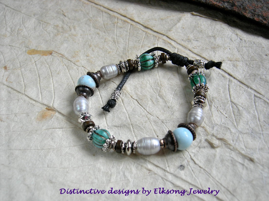 Elegant adjustable slider bracelet with white freshwater pearls, pale blue ceramic beads & turquoise colored glass melon beads. Silver & copper mixed metal.