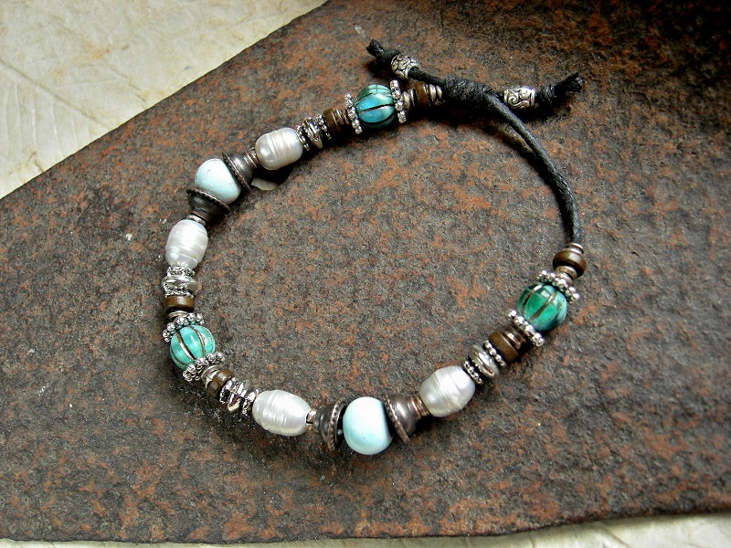 Sliding knot adjustable bracelet with white freshwater pearls, pale blue ceramic beads & turquoise colored glass melon beads. Silver & copper mixed metal.
