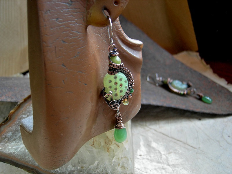 Iridescent spotted green nautilus earrings with oxidized copper wire wrap, jade beads & green glass tear drops.