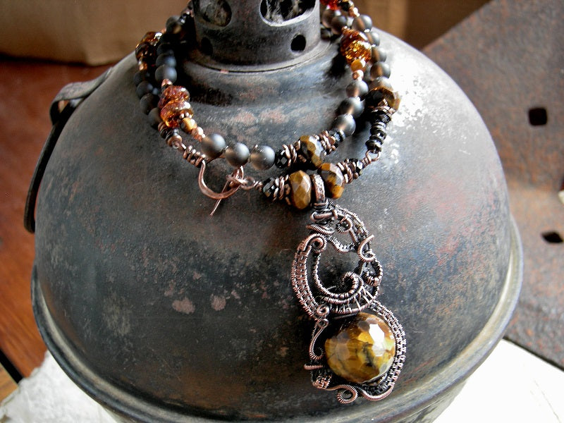 Boho luxe copper wire wrap art necklace, with ornate focal & strung smoky quartz, tiger eye, black tourmaline & amber beads.