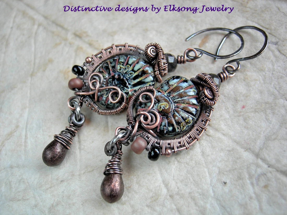 Black glass nautilus earrings with copper wire wrap, glass seed beads & drops and faceted black toumalinated quartz rounds.