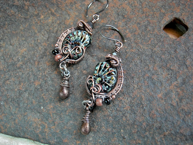 Picasso finish black glass nautilus earrings with copper wire wrap, glass seed beads & drops and faceted black toumalinated quartz rounds.