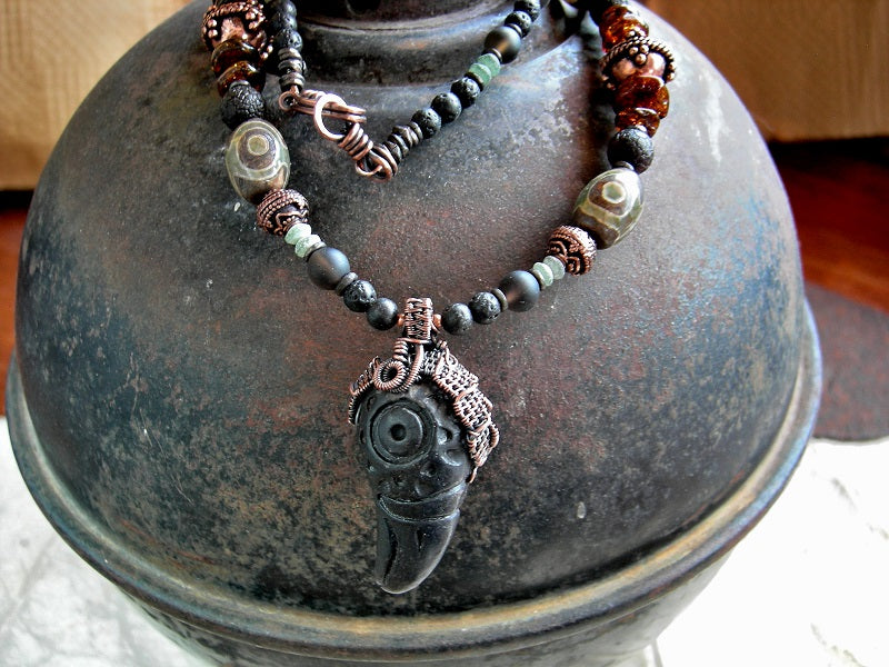 Dark, earthy boho necklace with black clay raven head & copper wire wrap focal, dark mix of gemstone & copper strung bead necklace.