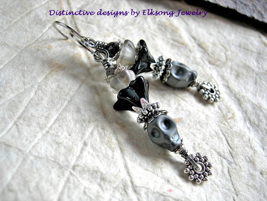 Dark gray sugar skull earrings with black & gray glass flowers, silver & faceted quartz beads. 
