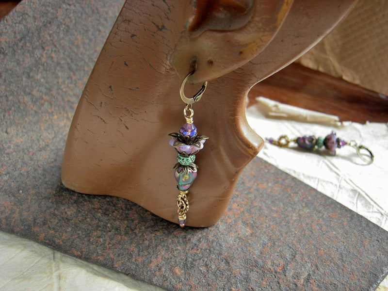 Colorful sugar skull earrings, with lilac & blue glass flowers, amethyst & iridescent hematite skull beads. 