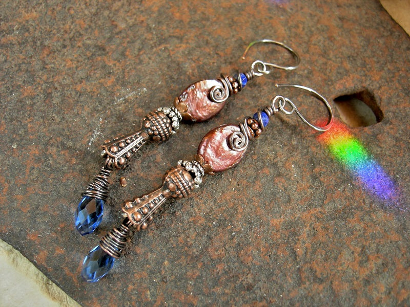 Boho luxe earrings with faceted lapis, copper iridescent freshwater pearl ovals, faceted blue crystal teardrops, copper & silver Bali style caps.