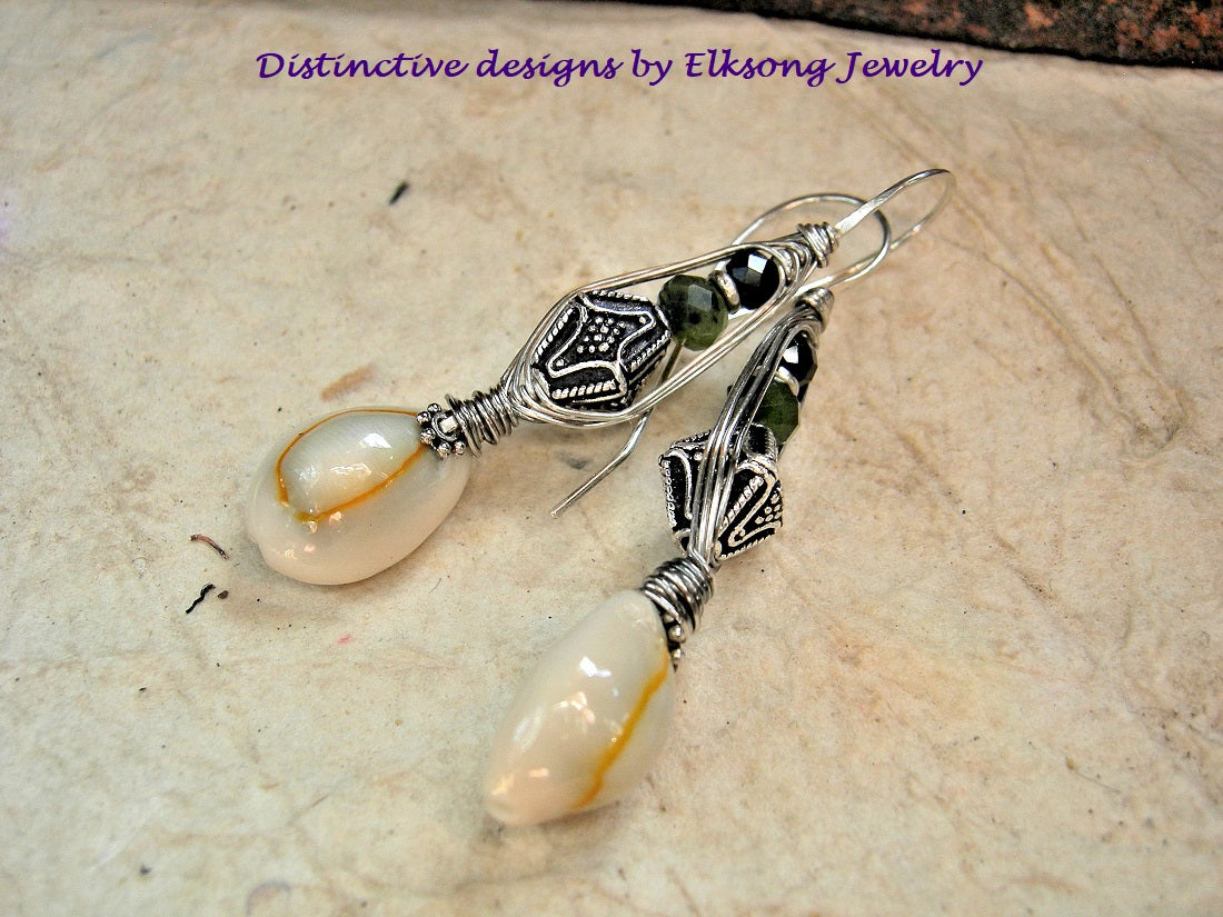 Cowrie shell wrapped sterling hook earrings with faceted jade, black toumaline & Bali style sterling-over-copper bi-cone beads.