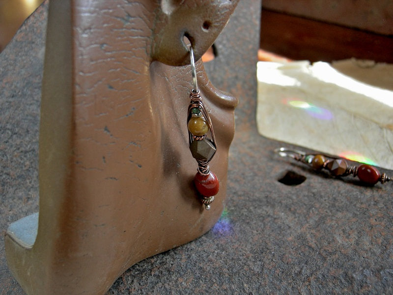 Copper wire wrapped sterling silver hook earrings with red, brown & gold gemstone.