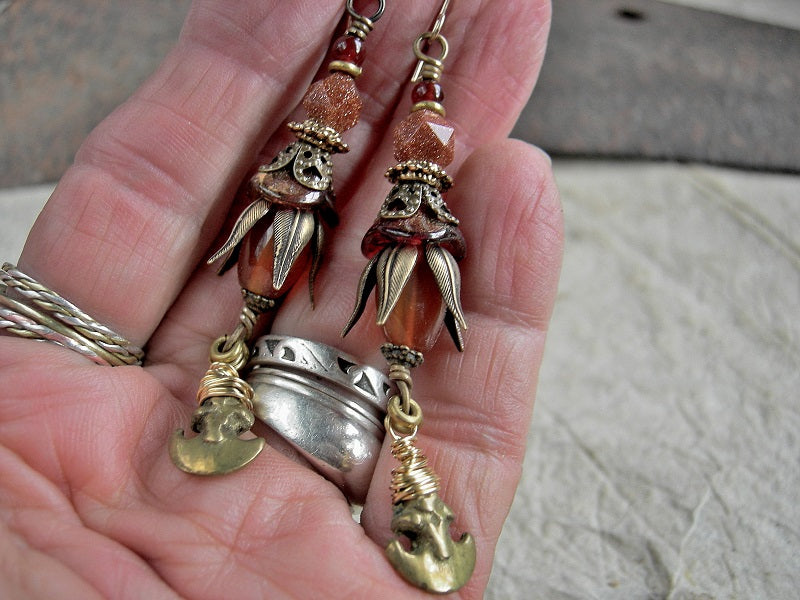 Elegant long earrings with carnelian, goldstone, glass flowers, antiqued brass caps & vintage ethnic brass crescent charms. 14kt gold filled ear wires.