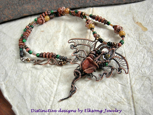 Copper wire wrap dragon strung bead necklace with goldstone, green tiger eye, golden jade, copper caps & beads.