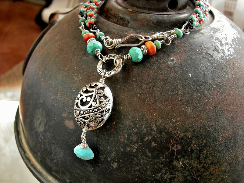 Woven seed bead necklace in turquoise, coral & black with turquoise & coral gemstone beads & silver filigree focal.