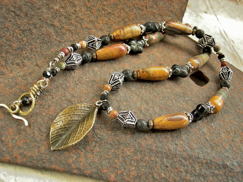 Strung bead necklace with earthy black & brown gemstone, sterling-over-copper beads & single antiqued bronze leaf focal.