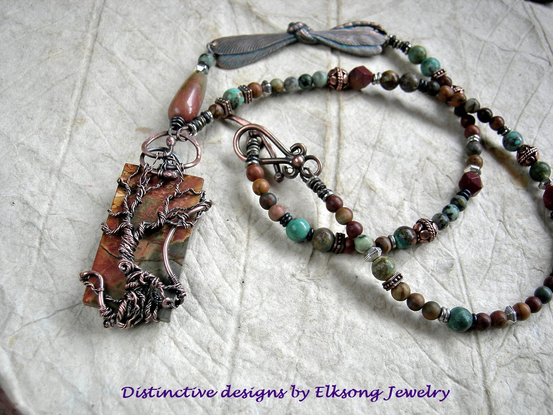 Desert Wander necklace with Red Creek jasper & copper wire wrap tree focal, copper, jasper & turquoise beads & verdigris copper dragonfly connector.