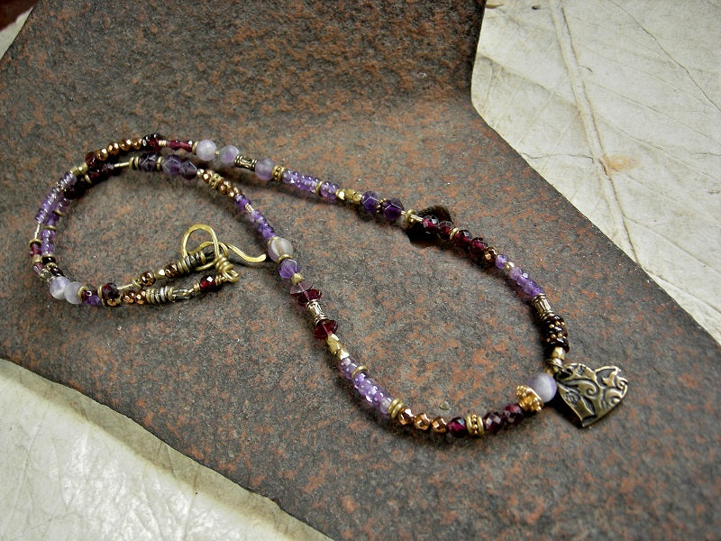 Triple wrap bracelet or necklace with strung purple amethyst, garnet, golden hematite, brass & gold beads and heart charm.