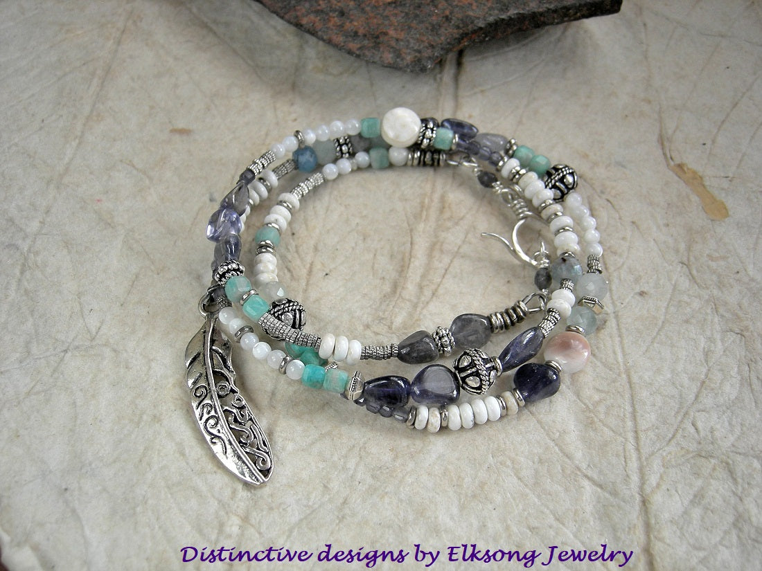 Fly Through the Storm wrap bracelet/necklace with blue & white gemstone beads, mother of pearl, sterling-over-copper beads, feather charm & sterling toggle clasp.