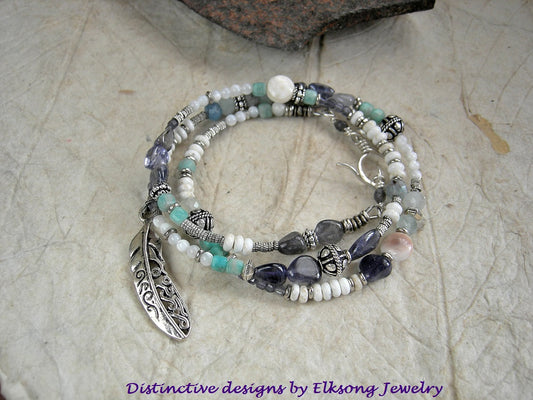 Fly Through the Storm wrap bracelet/necklace with blue & white gemstone beads, mother of pearl, sterling-over-copper beads, feather charm & sterling toggle clasp.