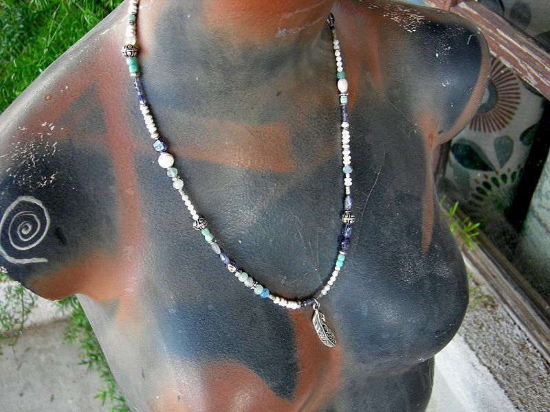 Strung bead necklace with blue & white gemstone beads, mother of pearl, sterling-over-copper beads, feather charm & sterling toggle clasp.
