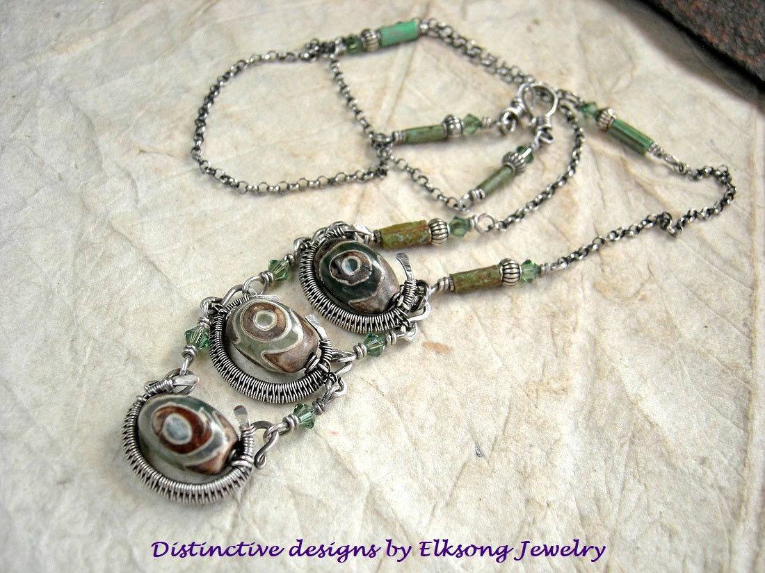 Slinky agate & silver pendant with etched green/brown agate beads, sterling wire wrap, green Swarovski crystals & sterling chain.