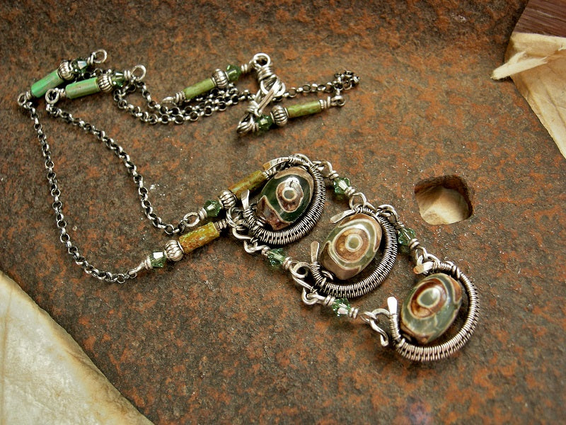 Elegant Tibetan agate & silver pendant with etched green/brown agate beads, sterling wire wrap, green Swarovski crystals & sterling chain.