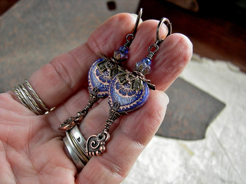 Elegant earrings with blue glass & copper hearts, glass flower beads, blue faceted crystal rondelles & antiqued copper filigree.