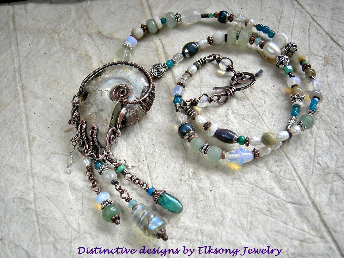 Nautilus Treasure necklace with natural ammonite fossil in copper wire wrap & abstract mix of ocean color gemstone, opalite, glass & pearl beads.