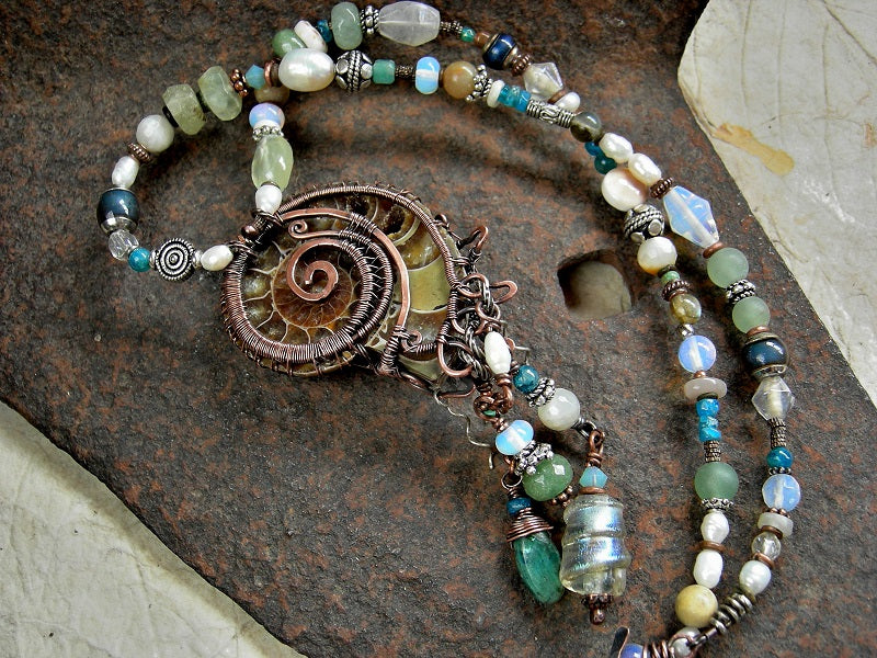 Reversible strung bead necklace with natural ammonite fossil in copper wire wrap & abstract mix of ocean color gemstone, opalite, glass & pearl beads.