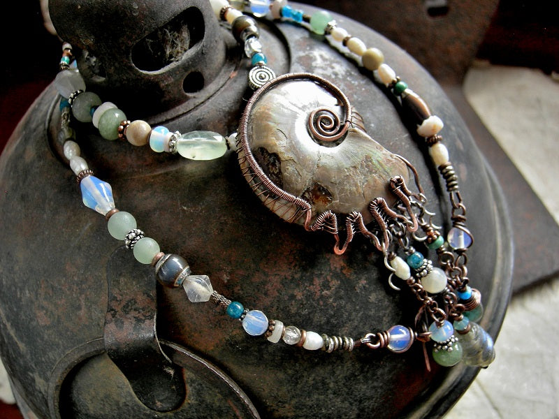 Ocean theme statement necklace with natural ammonite fossil in copper wire wrap & abstract mix of ocean color gemstone, opalite, glass & pearl beads.