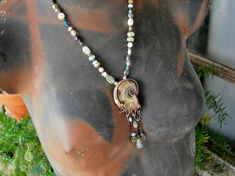 Boho luxe statement necklace with natural ammonite fossil in copper wire wrap & abstract mix of ocean color gemstone, opalite, glass & pearl beads.