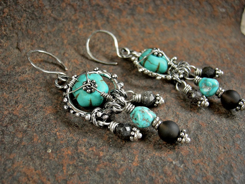 Chandelier style earrings with turquoise colored magnesite, silver finish granulation rings, smoky & black tourmalated quartz rounds & Morenci turquoise nuggets.