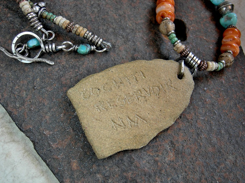 Inscribed petroglyph necklace with artisan made ceramic focal, strung turquoise, spiny oyster shell, picture jasper & sterling silver beads.