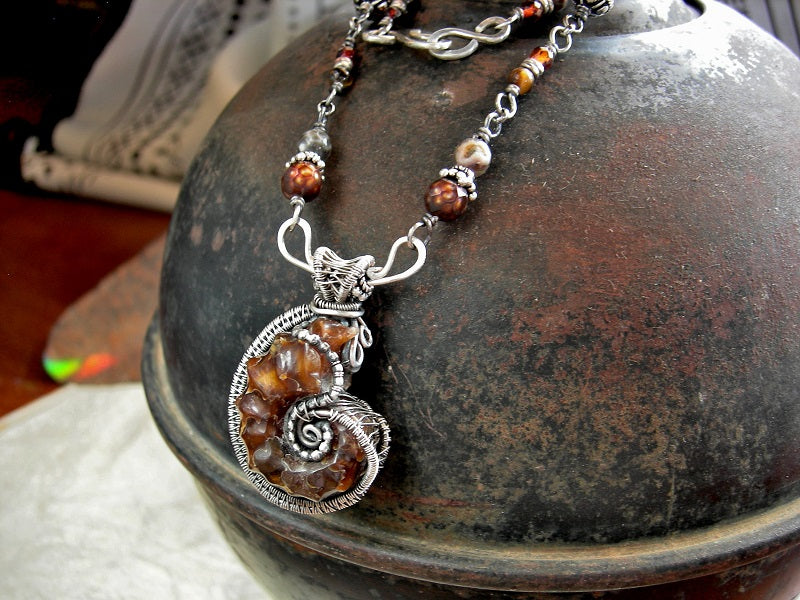 Boho elegant sterling wire wrapped ammonite necklace. Beaded sterling wrapped links with faceted amber, colored freshwater pearl, brown agate & tiger eye.