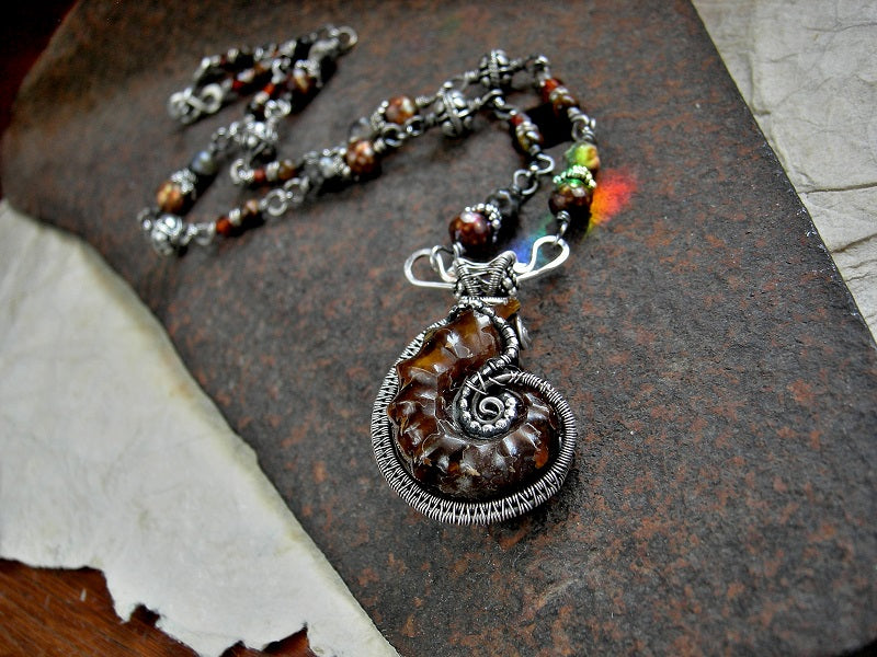 Oxidized sterling wire wrapped ammonite necklace with beaded sterling wrapped links with faceted amber, colored freshwater pearl, brown agate & tiger eye.