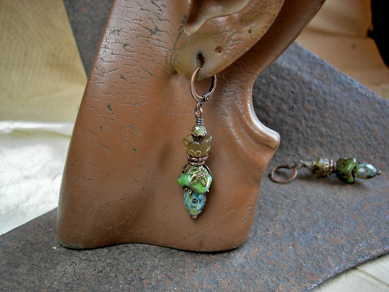 Woodland flower earrings with green & brown glass & resin flowers, faceted glass beads & antiqued copper & brass details.