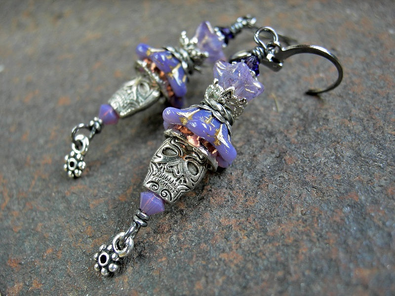 Boho sugar skull earrings with lavender glass flowers, silver metal skull beads & Swarovski crystals.