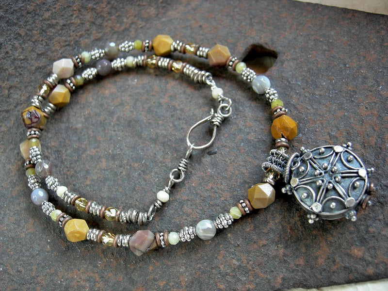 Faceted yellow gemstone bead necklace with silver Bali focal, silver & copper heishi & hook and eye clasp.