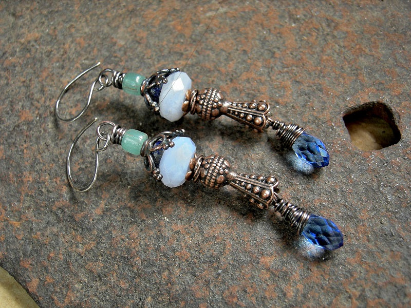 Elegant, detailed earrings with blue gemstone, crystal tear drops & vintage Java glass beads. Antiqued copper caps & wire wrap.