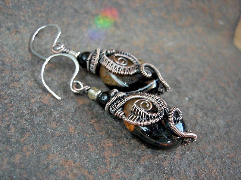 Boho elegant ear drops with oval, dark crab agate beads in oxidized copper wire wrap. Black amber & pale gold citrine accent beads.