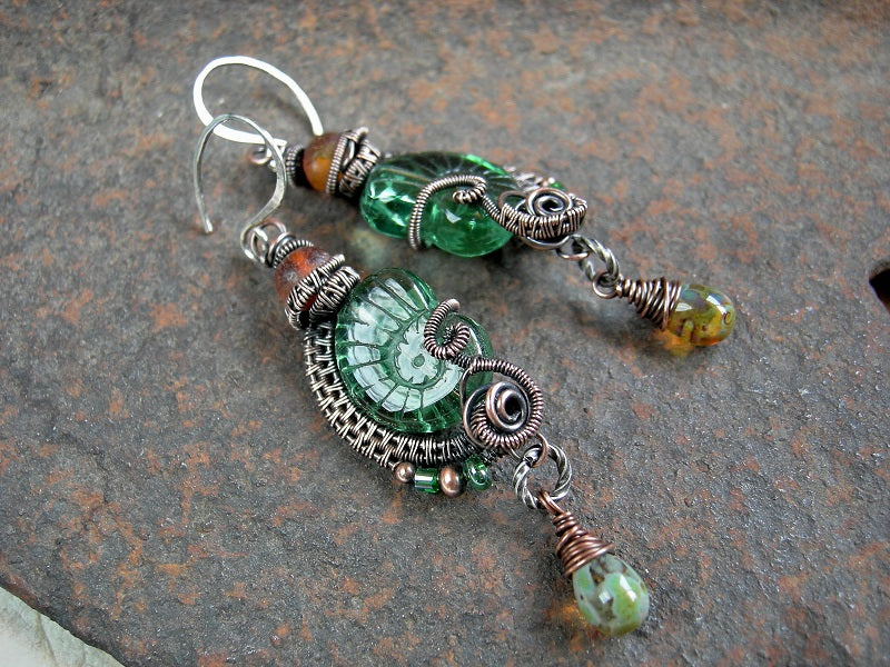Boho luxe pressed Czech glass nautilus earrings in sea green & amber. Oxidized copper wire wrap & sterling ear wires.