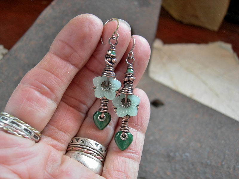 Earthy elegant earrings with green glass flower & leaf beads, faceted crystal rondelles, copper details & wire wrapping. 