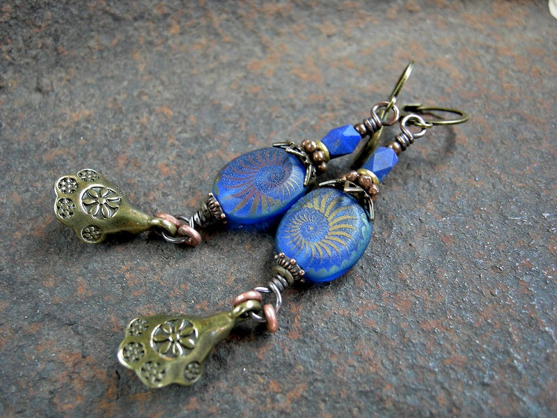 Boho luxe earrings with oval blue glass, nautilus decorated beads, faceted lapis & antiqued gold scallop drops. 