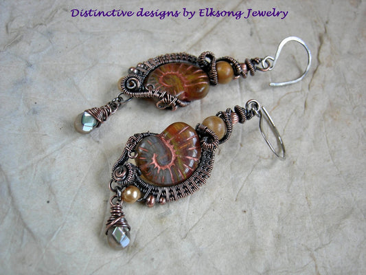 Autumn gold nautilus earrings with dark amber glass nautilus beads, oxidized copper wire wrap, fossilized coral & faceted abalone drops. 