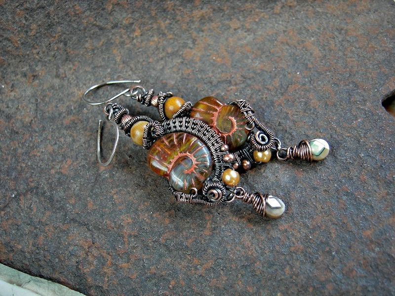 Dark amber glass nautilus earrings with oxidized copper wire wrap, fossilized coral & faceted abalone drops. 