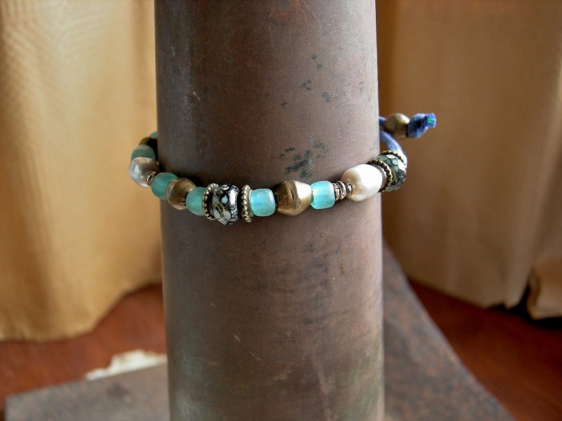 Boho pearl adjustable slider bracelet with aqua Java glass, African brass & faceted black & Picasso finish Czech glass roller beads. 
