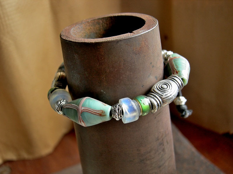 Unisex adjustable sliding knot bracelet with aqua Java glass bi cone beads, Greek pewter beads, Dutch opal glass & glass color change beads. 