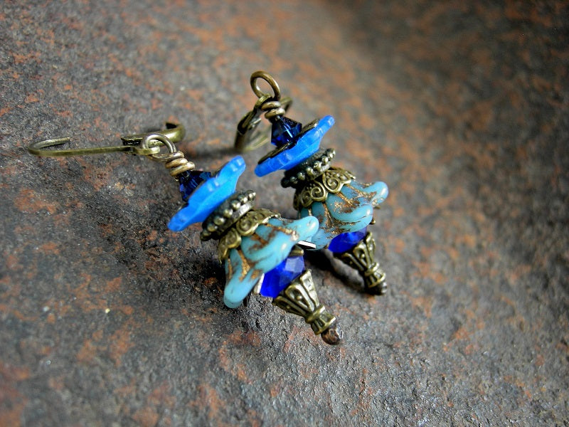 Faery couture flower earrings in shades of blue  with glass & resin flowers, antiqued brass details & Swarovski crystals. 