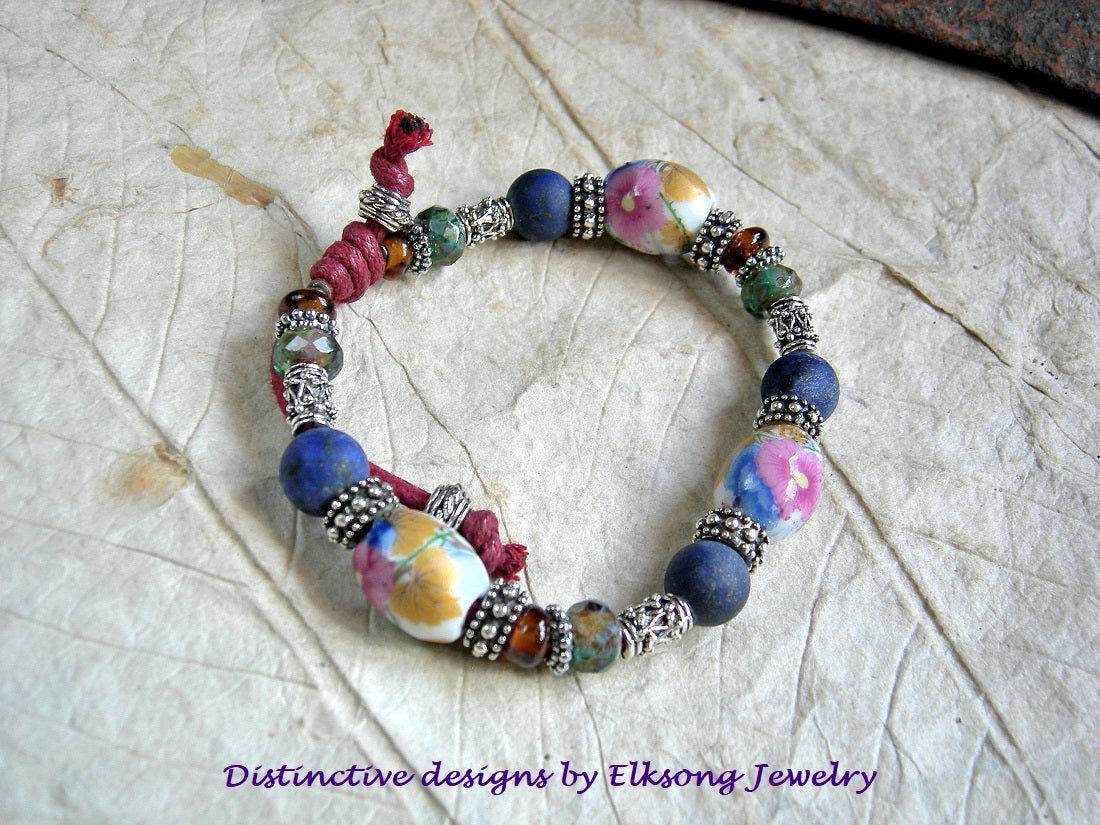 Flowery Field adjustable cord & bead bracelet with vintage porcelain, matte lapis, amber Indonesian glass & Bali style silver beads. 