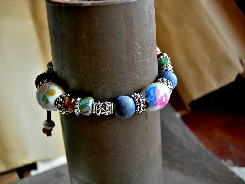 Sliding knot cord & bead bracelet with vintage porcelain, matte lapis, amber Indonesian glass & Bali style silver beads. 
